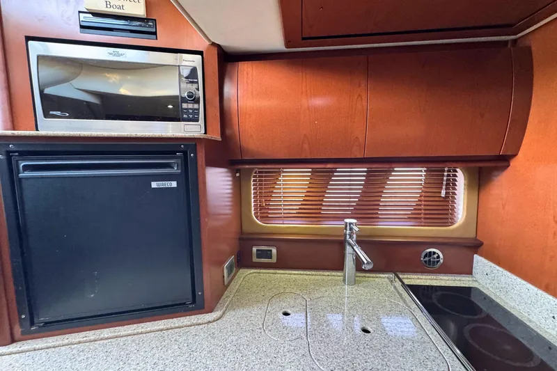 Slide: The Image of 2008 Sea Ray 38 Sundancer kitchen with microwave, fridge, and sink. - 28