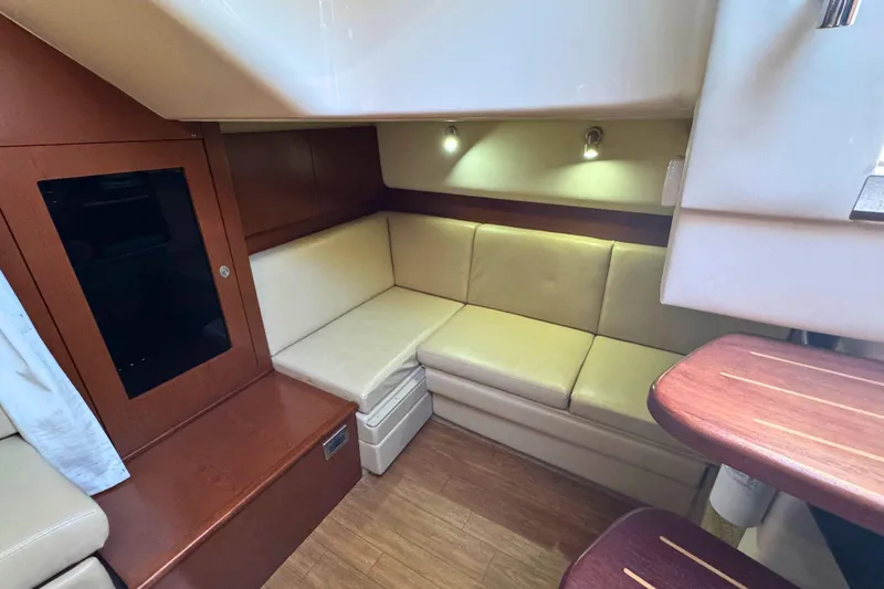 Slide: The Image of Interior of 2008 Sea Ray 38 Sundancer yacht with beige seating and wooden accents. - 31