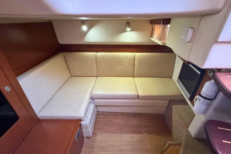 Slide: The Image of Interior of 2008 Sea Ray 38 Sundancer with beige seating and wood accents. - 32