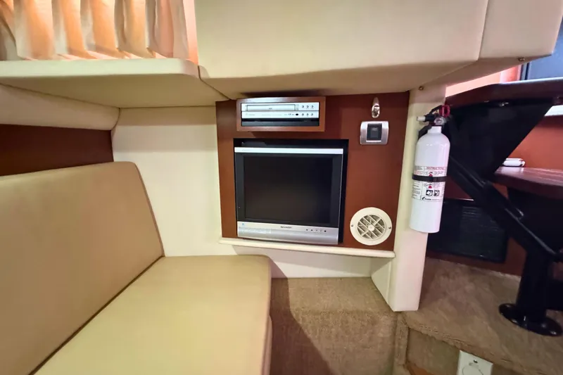 Slide: The Image of 2008 Sea Ray 38 Sundancer interior with TV, DVD player, and fire extinguisher. - 34