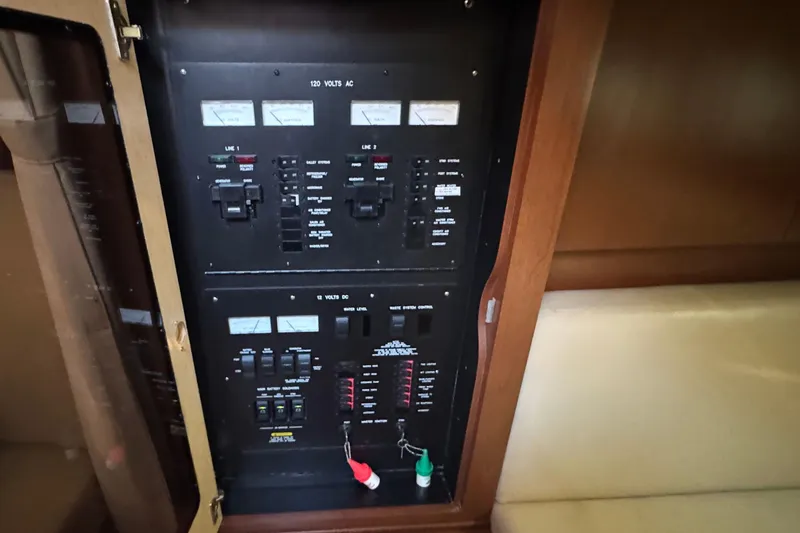 Slide: The Image of Electrical panel inside 2008 Sea Ray 38 Sundancer boat, featuring various switches and meters. - 36