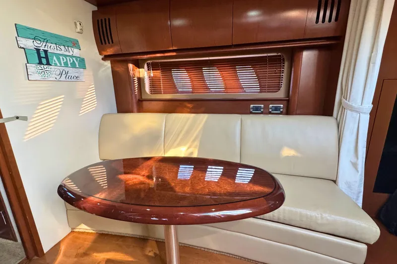 Slide: The Image of Interior of 2008 Sea Ray 38 Sundancer with cozy seating and wooden table. - 37