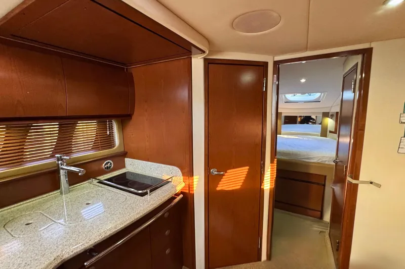 Slide: The Image of 2008 Sea Ray 38 Sundancer interior with kitchenette and cozy bedroom. - 38