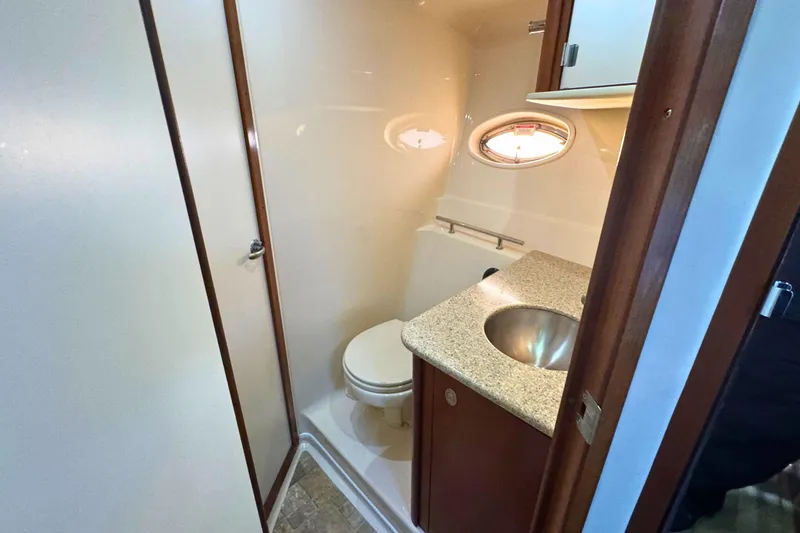 Slide: The Image of Compact bathroom in 2008 Sea Ray 38 Sundancer yacht with sink and porthole. - 42