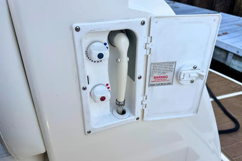 Slide: The Image of 2008 Sea Ray 38 Sundancer boat shower controls with warning label. - 52
