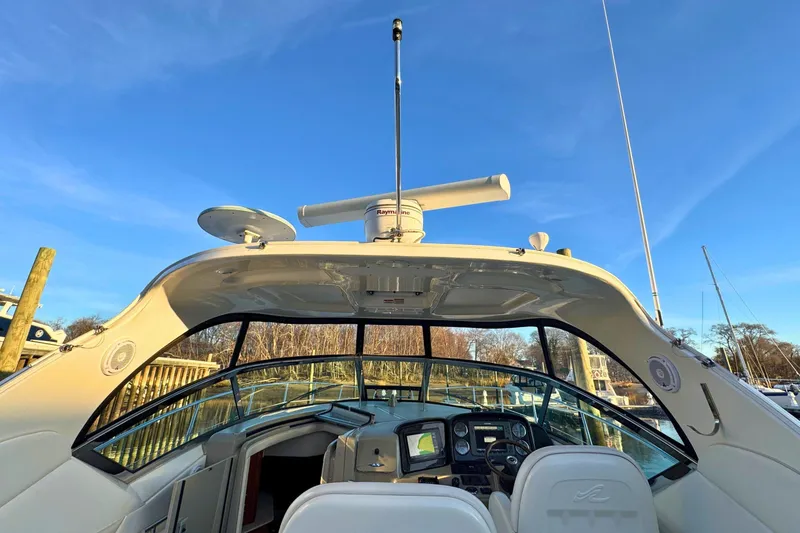 Slide: The Image of 2008 Sea Ray 38 Sundancer cockpit with navigation equipment under clear blue sky. - 53