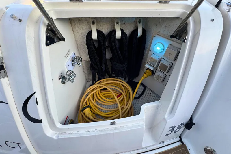 Slide: The Image of Storage compartment of a 2008 Sea Ray 38 Sundancer with cables and controls. - 58