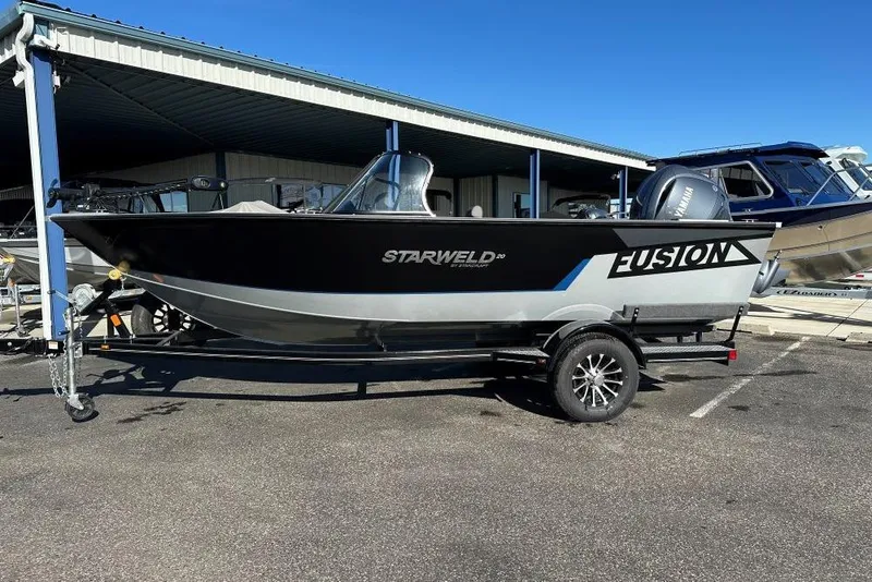 Slide: The Image of 2025 Starweld Fusion Pro 20 DC boat interior with seating and steering wheel. - 13