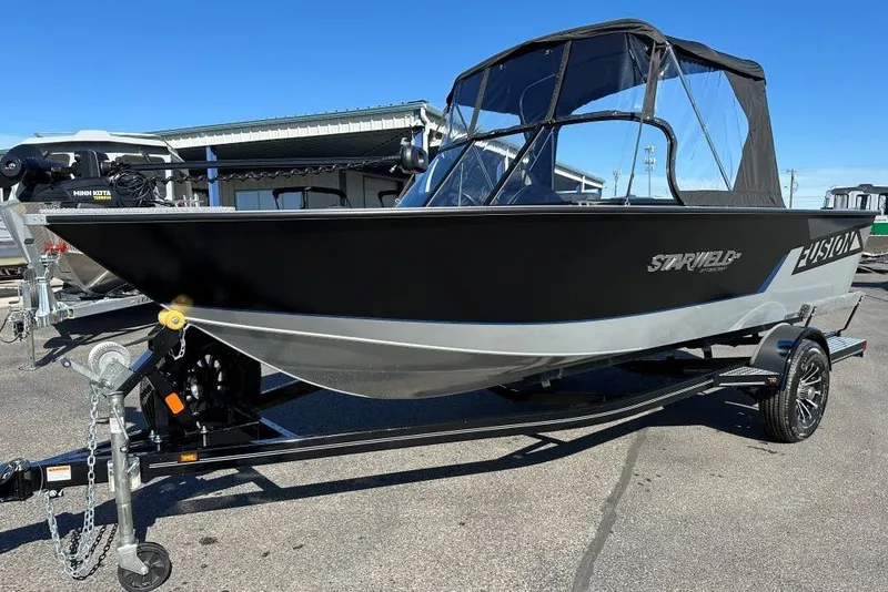 Slide: The Image of 2025 Starweld Fusion Pro 20 DC boat on trailer, black and silver design. - 2