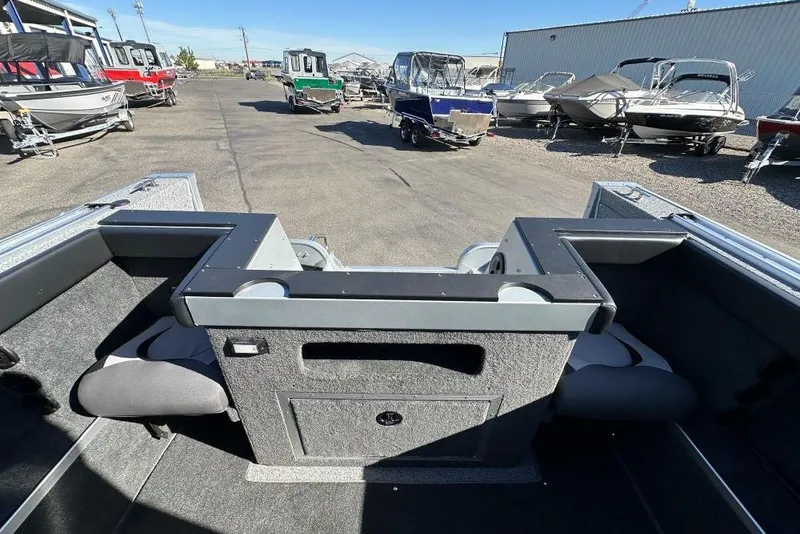 Slide: The Image of 2025 Starweld Fusion Pro 20 DC boat on trailer, covered and parked outdoors. - 9