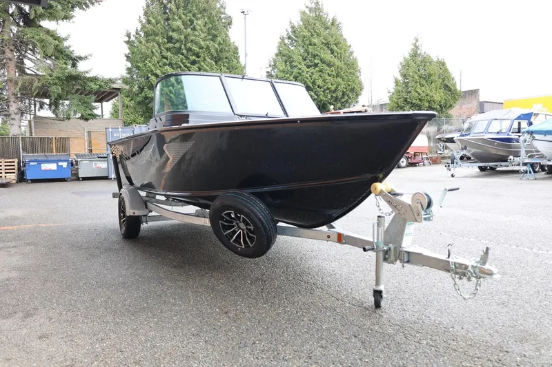 Slide: The Image of 2026 Lund 1775 Adventure Sport boat on trailer, parked outdoors. - 10