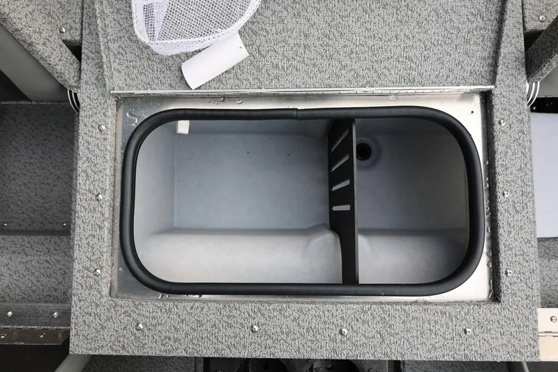 Slide: The Image of Livewell compartment in 2026 Lund 1775 Adventure Sport boat, featuring gray carpeted interior. - 20