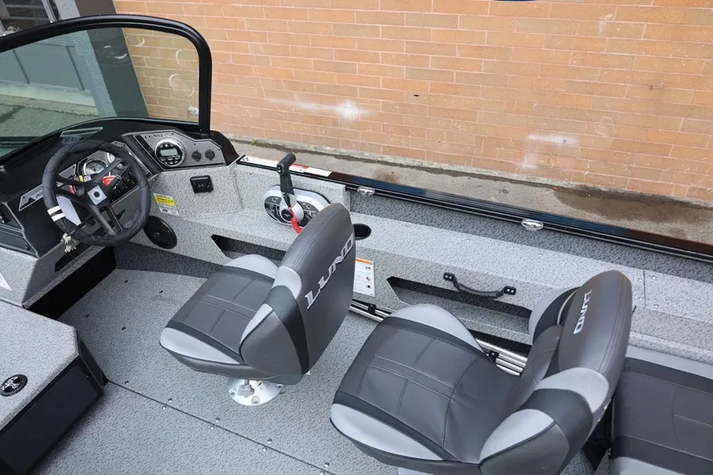Slide: The Image of 2026 Lund 1775 Adventure Sport boat interior with steering wheel and seats. - 21