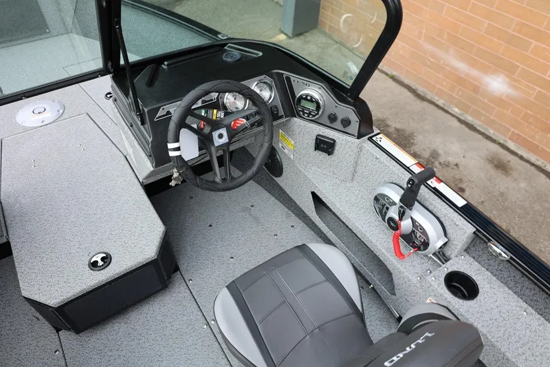 Slide: The Image of 2026 Lund 1775 Adventure Sport boat interior with steering wheel and control panel. - 22
