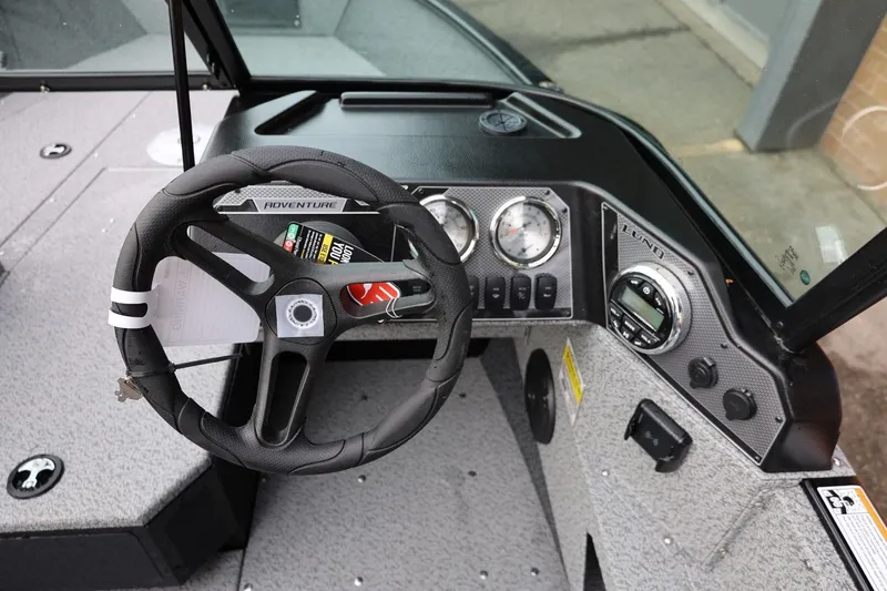 Slide: The Image of 2026 Lund 1775 Adventure Sport boat dashboard with steering wheel and instrument panel. - 23