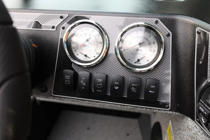 Slide: The Image of Dashboard of 2026 Lund 1775 Adventure Sport with gauges and control switches. - 25