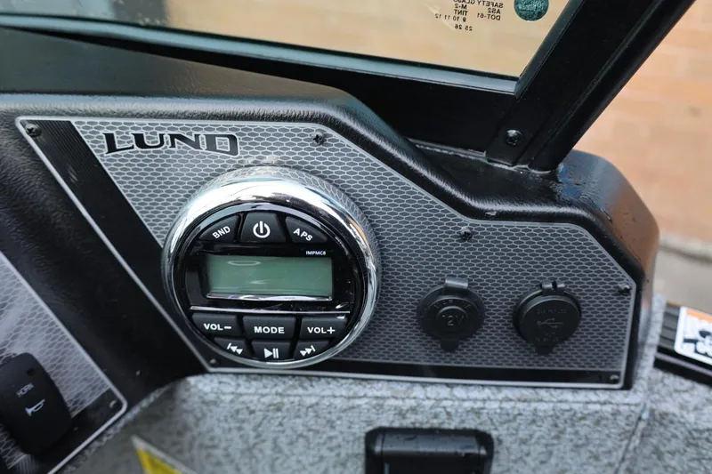 Slide: The Image of Control panel of 2026 Lund 1775 Adventure Sport boat with audio system and power outlets. - 26