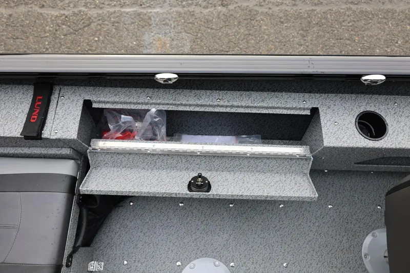 Slide: The Image of Interior view of 2026 Lund 1775 Adventure Sport boat, featuring storage compartment and seating. - 30