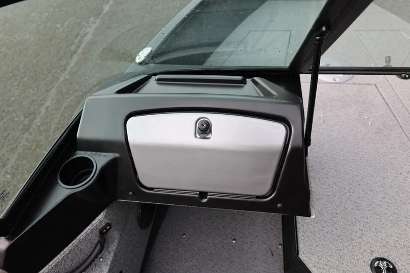 Slide: The Image of 2026 Lund 1775 Adventure Sport boat dashboard with glove compartment and cup holder. - 34