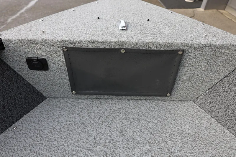 Slide: The Image of Interior of 2026 Lund 1775 Adventure Sport boat, featuring gray carpeted storage area. - 40