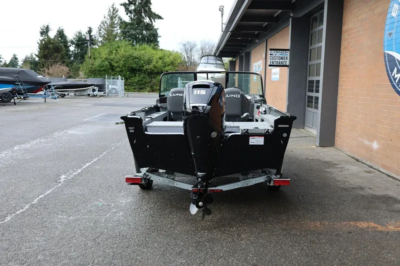 Slide: The Image of 2026 Lund 1775 Adventure Sport boat with Mercury 115 engine, parked outside dealership. - 5