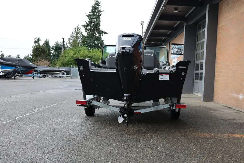 Slide: The Image of 2026 Lund 1775 Adventure Sport boat on trailer, rear view, parked outdoors. - 6