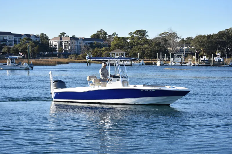 The Image of 2017 NauticStar 231 Angler boat cruising on a calm waterway near a marina. - 0