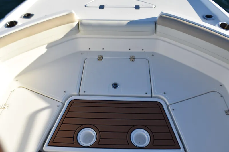 Slide: The Image of 2017 NauticStar 231 Angler boat deck with seating and storage compartments. - 10