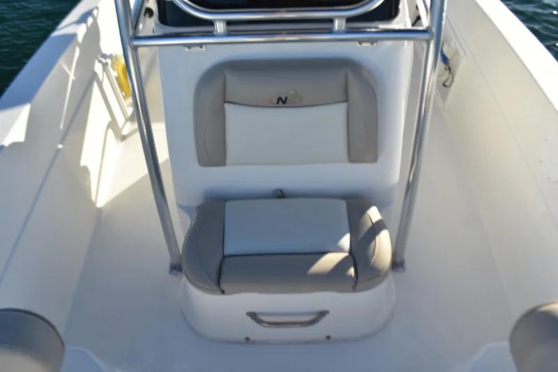 Slide: The Image of 2017 NauticStar 231 Angler boat interior with cushioned seating and stainless steel railing. - 12