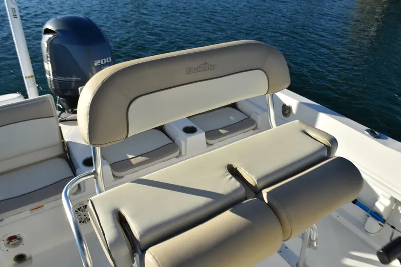 Slide: The Image of 2017 NauticStar 231 Angler boat interior with seating and outboard motor. - 14