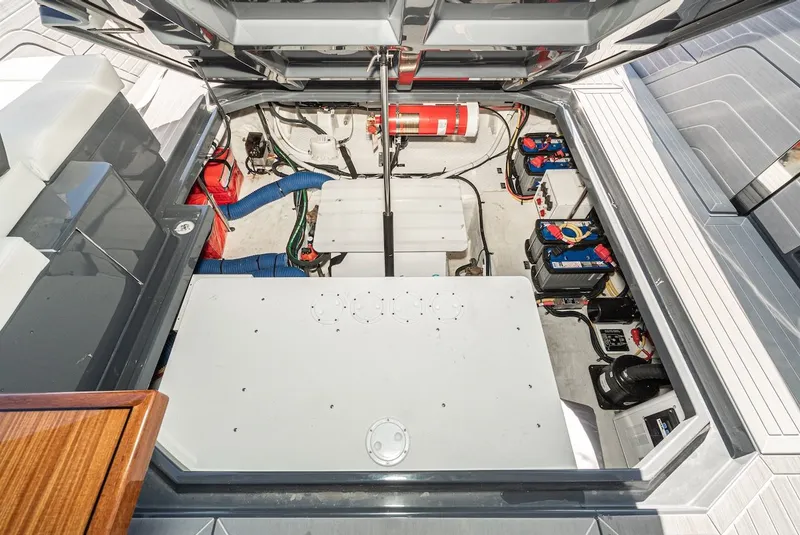 Slide: The Image of Engine compartment of 2023 Cruisers Yachts 42 GLS with batteries and fire extinguisher. - 40