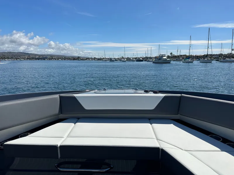 Slide: The Image of 2023 Cruisers Yachts 42 GLS on calm waters with harbor view. - 48