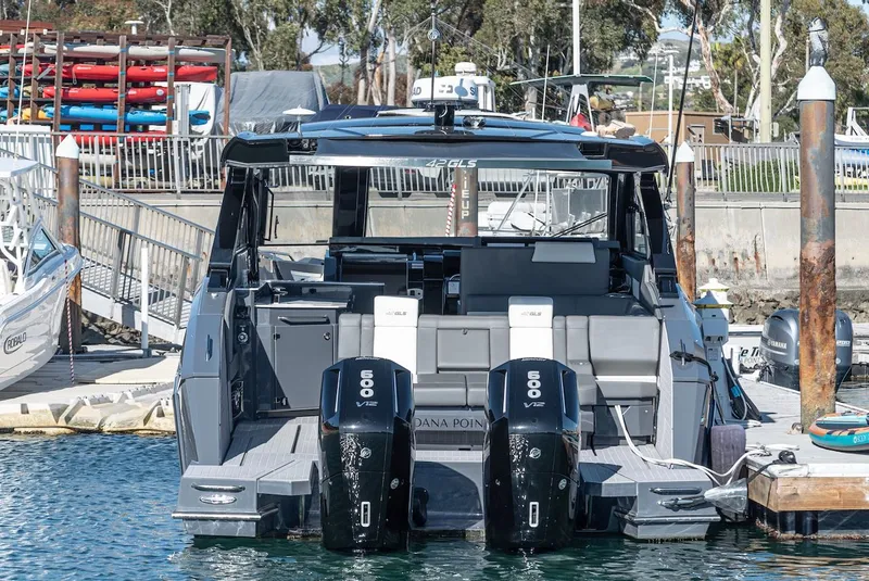 Slide: The Image of 2023 Cruisers Yachts 42 GLS docked with dual outboard engines. - 5