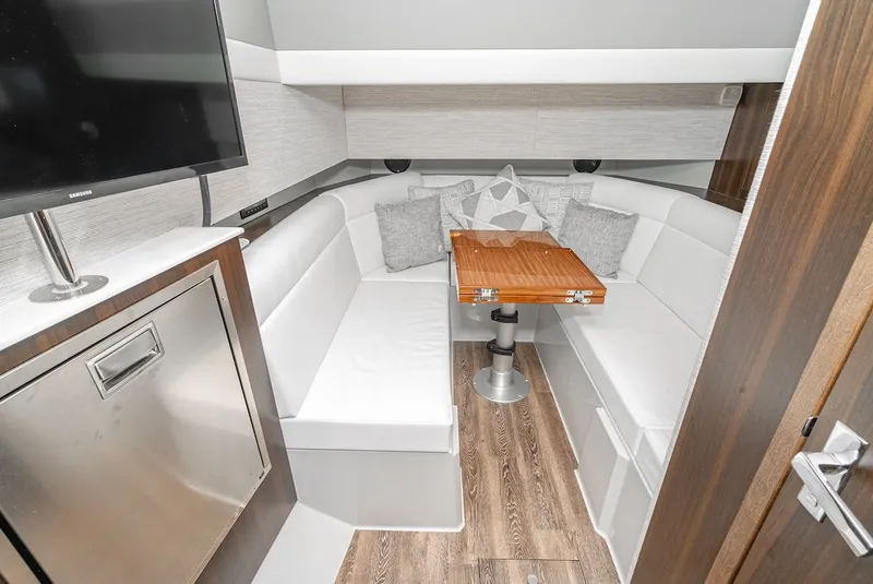 Slide: The Image of Interior of 2023 Cruisers Yachts 42 GLS with white sofa and wooden table. - 32