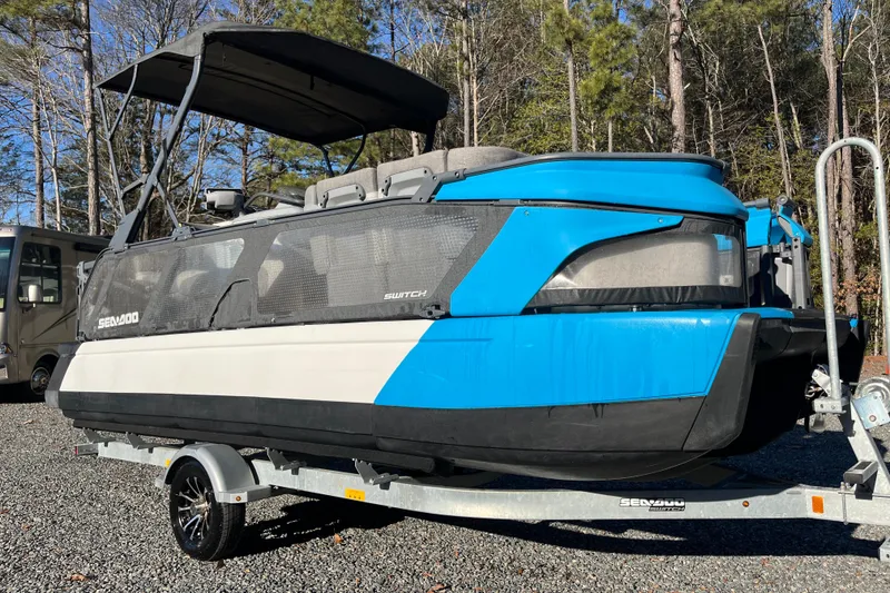 The Image of 2023 Sea-Doo Switch Cruise 21 on trailer, parked outdoors with trees in background. - 1