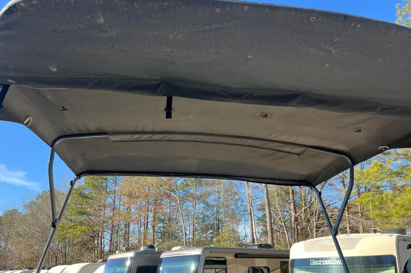 Slide: The Image of 2023 Sea-Doo Switch Cruise 21 canopy with RVs and trees in the background. - 22