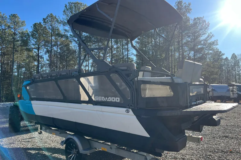 Slide: The Image of 2023 Sea-Doo Switch Cruise 21 pontoon boat on trailer in sunny outdoor setting. - 3