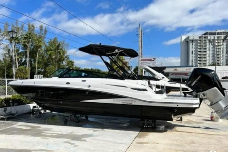 The Image of 2022 Monterey M-65 boat on display, black and white design, outdoor setting. - 0