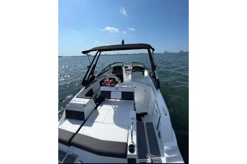 Slide: The Image of 2022 Monterey M-65 boat on open water, featuring sleek design and spacious deck. - 3