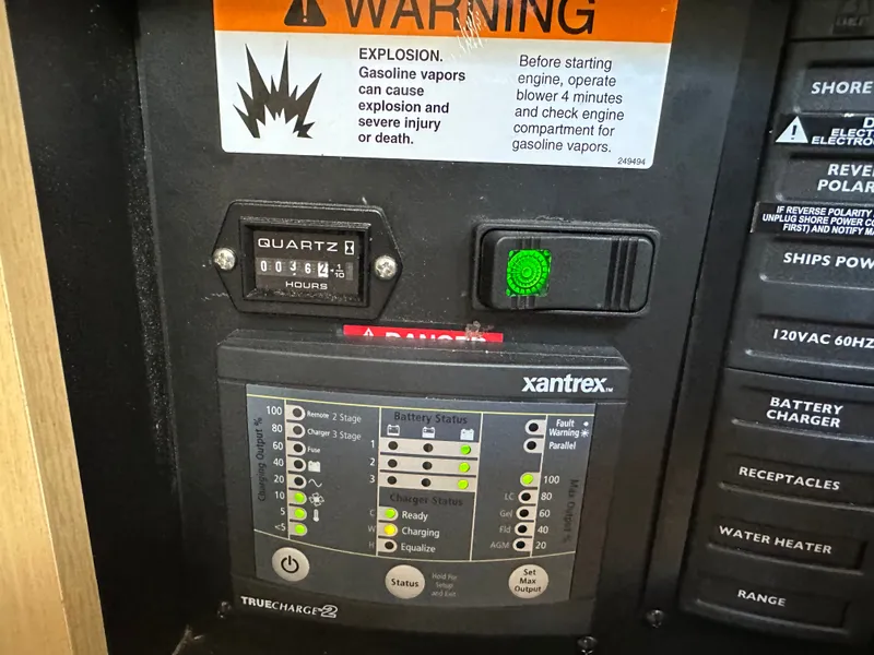 Slide: The Image of Bayliner 335 Cruiser 2012 control panel with warning label and Xantrex charger. - 17