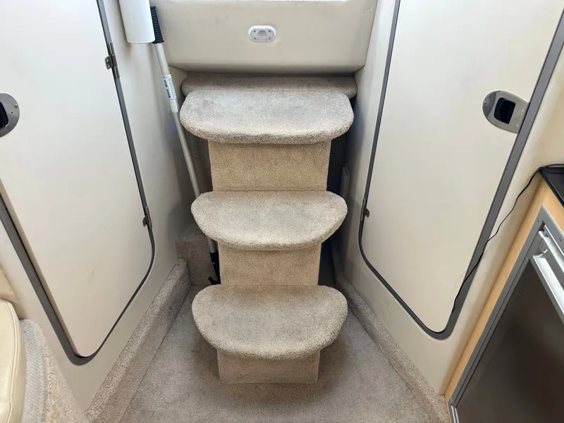 Slide: The Image of Carpeted steps inside a 2012 Bayliner 335 Cruiser. - 18