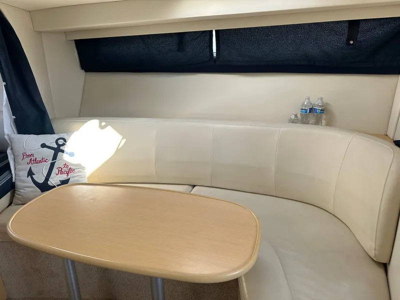 Slide: The Image of Interior of 2012 Bayliner 335 Cruiser with table and cushion. - 20