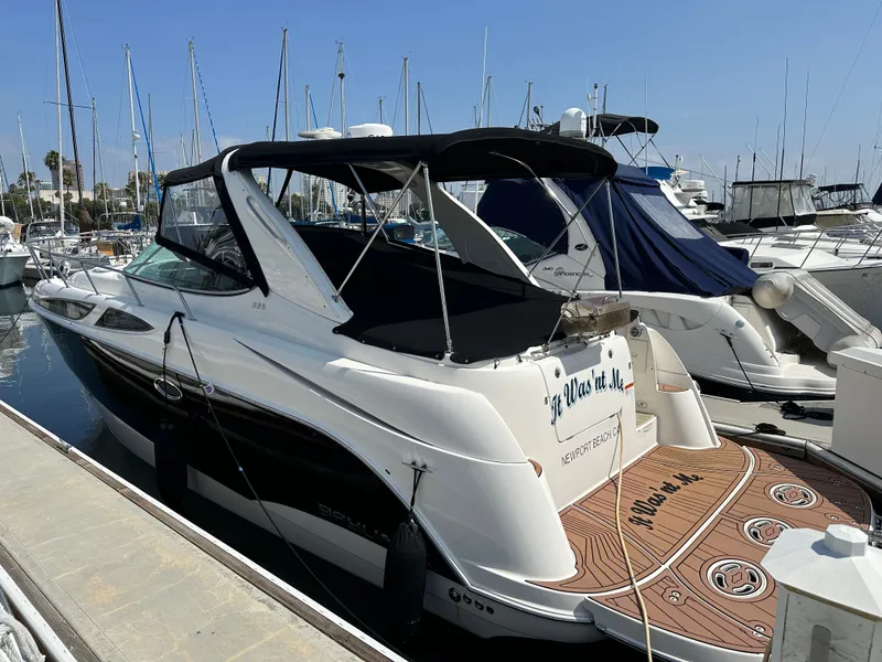 Slide: The Image of 2012 Bayliner 335 Cruiser docked at marina, side view. - 5