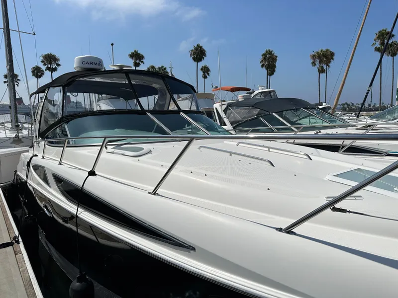 Slide: The Image of 2012 Bayliner 335 Cruiser docked with palm trees in the background. - 7