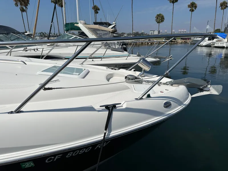 Slide: The Image of 2012 Bayliner 335 Cruiser docked with palm trees in the background. - 8