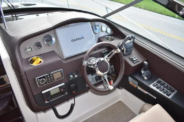 Slide: The Image of Helm of 2015 Regal 32 Express boat with Garmin navigation system and controls. - 10
