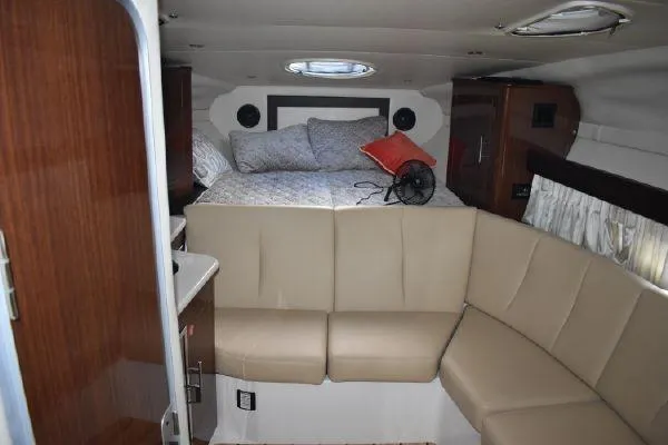 Slide: The Image of Interior of 2015 Regal 32 Express boat with cozy seating and bed area. - 13