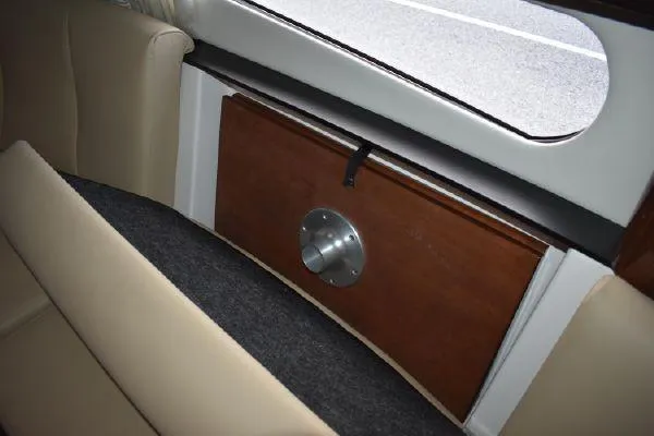 Slide: The Image of Interior view of 2015 Regal 32 Express boat with beige seating and wooden panel. - 16