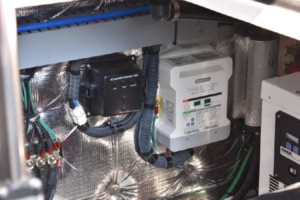 Slide: The Image of Electrical components inside a 2015 Regal 32 Express boat engine compartment. - 22