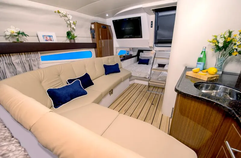 Slide: The Image of 2015 Regal 32 Express boat with cover, parked outside a blue building. - 4